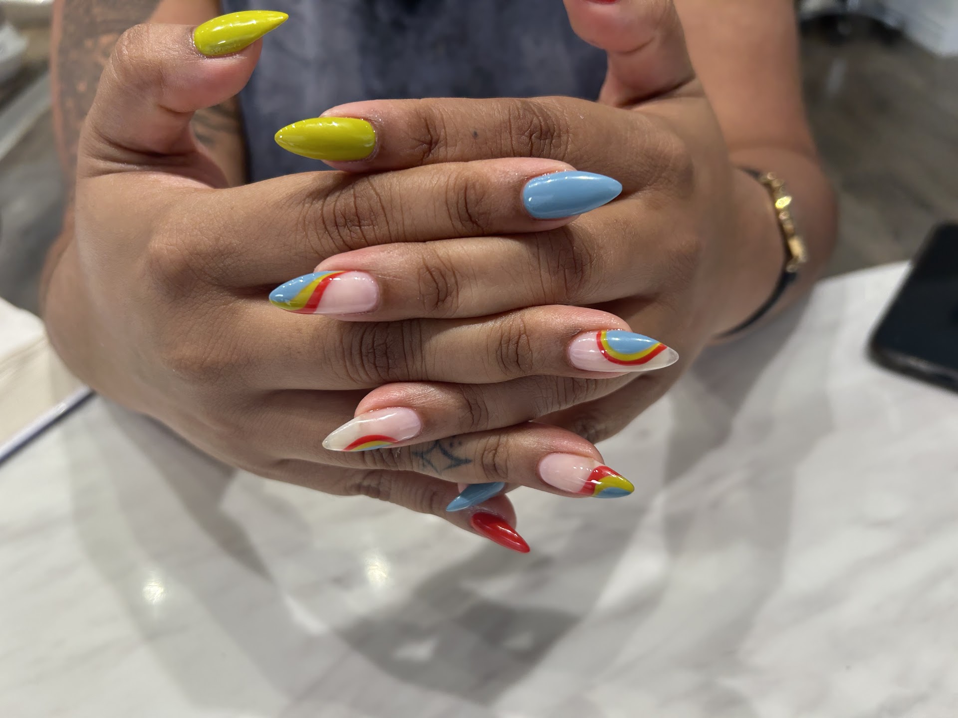 Colorful almond nails with curved accent designs