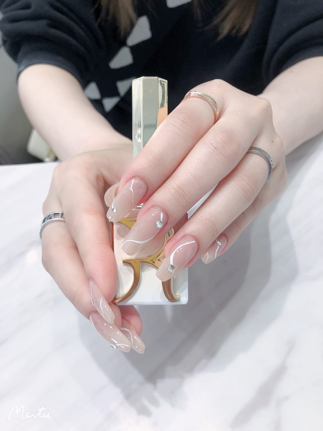 Glossy nude nails with rhinestone accents