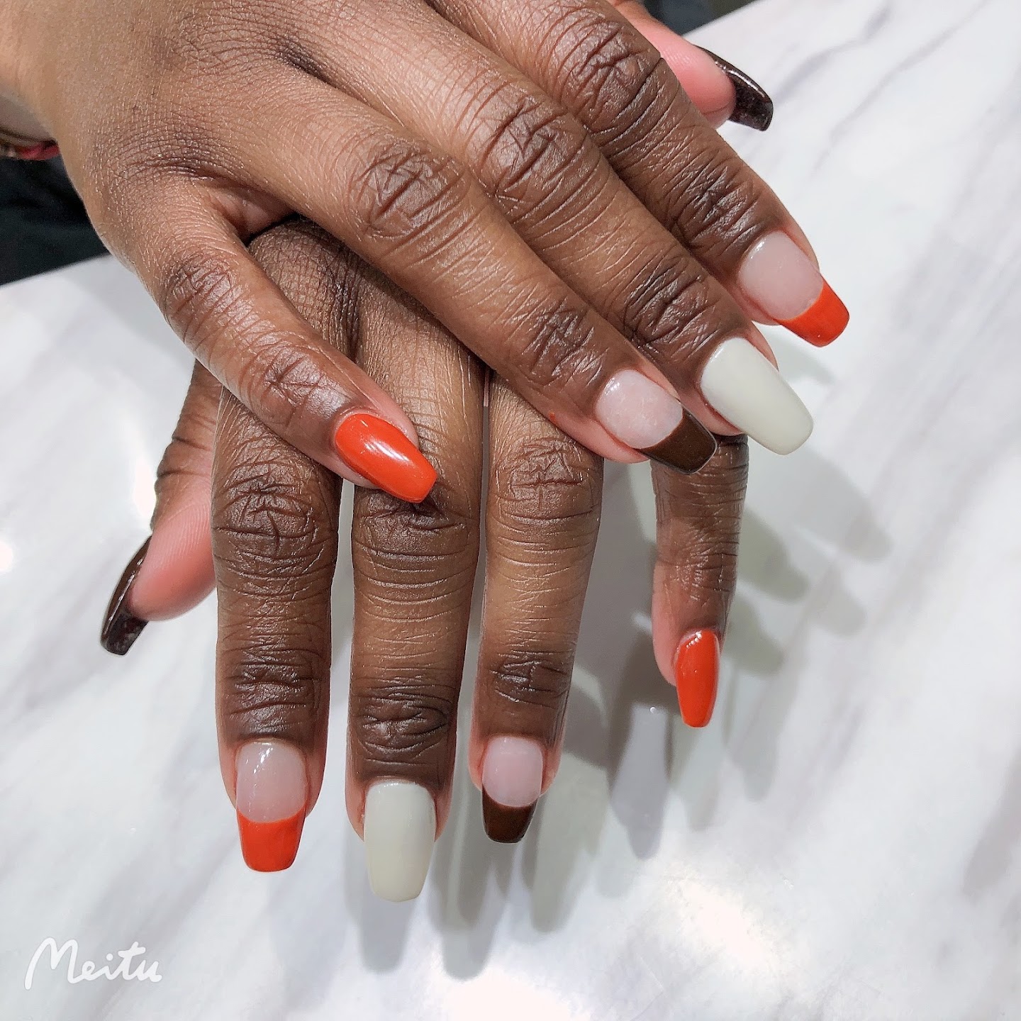 Orange, cream, and brown manicure