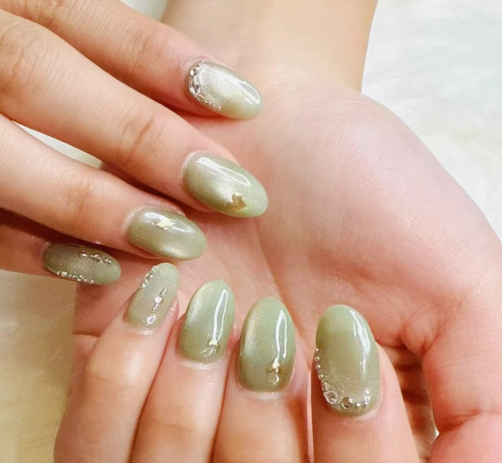 Sage almond nails with rhinestone accents