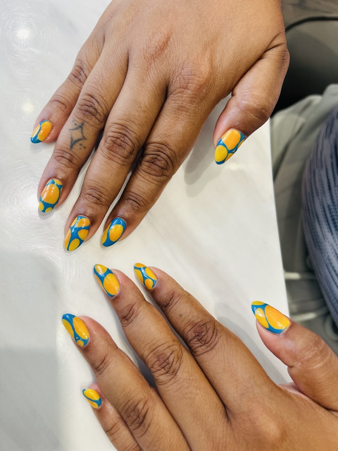 Bright yellow and blue abstract nails